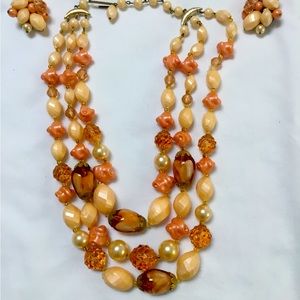 West Germany Stamp necklace 18”with matching clip on earrings.Peach/coral color